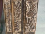 a close up of a wooden door with carvings on it