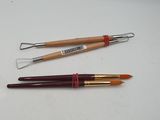 two different types of crochet brushes on a white surface