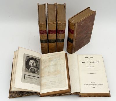three old books sitting on top of each other on a table