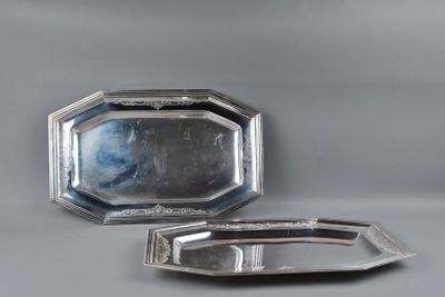 two silver trays sitting on top of a table next to each other