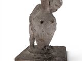 statue of a man with a bent head on a square base