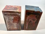 two pieces of art that are sitting on a table