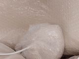 a ball of bubble sitting on top of a bed