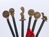 a red flag on top of a pole with a bunch of swords