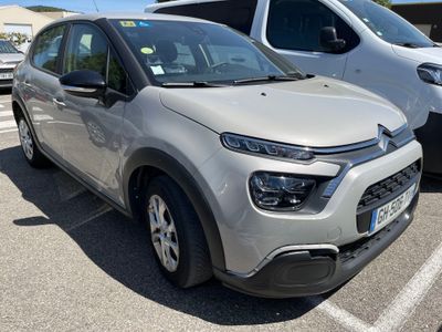 une Citroën argentée garée sur un parking à côté d'autres voitures
