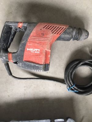 a drill and a cord on the floor next to a drill