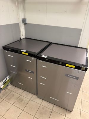 two refrigerators that are sitting in the corner of a room