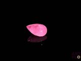 a pink hat sitting on top of a black surface