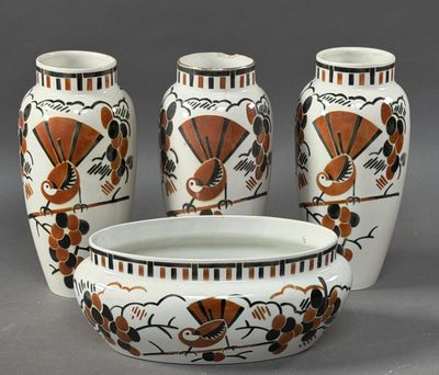 three vases and a bowl sitting on a table