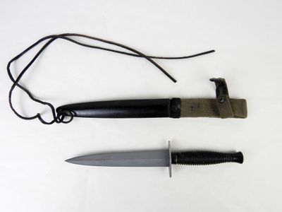 a knife and a cord on a white surface