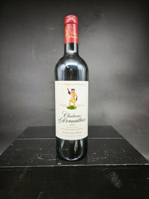 la bouteille de vin rouge est posée sur une boîte noire