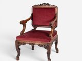 an old chair with a red upholstered seat on a white background