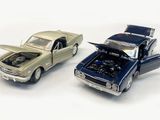 two toy cars that are next to each other on a white surface