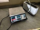 an image of a scale with a toaster and toaster on it