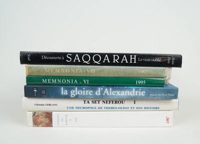 several books stacked on top of each other on a white surface