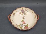 a plate with flowers on it sitting on a table
