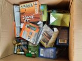 a cardboard box filled with assorted items like cigarettes and cigarettes