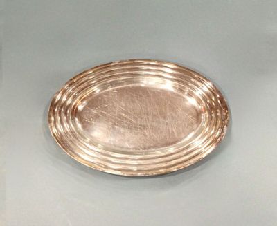 a silver plate sitting on top of a glass table
