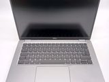 an open laptop computer sitting on top of a white table