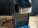 a coffee maker that is sitting on a wooden table