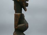 a close up of a wooden sculpture on a white surface