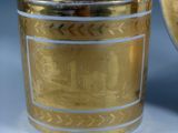 a gold cup that is sitting on a table