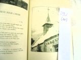 an open book with a picture of a church on it