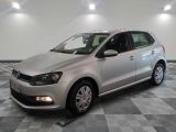 the silver volkswagen polo is parked on a checkered tile floor