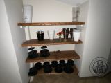 a shelf with cups and plates on it in a room