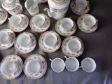 a lot of cups and saucers on a table