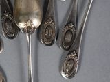 five spoons and two spoon spoons on the table