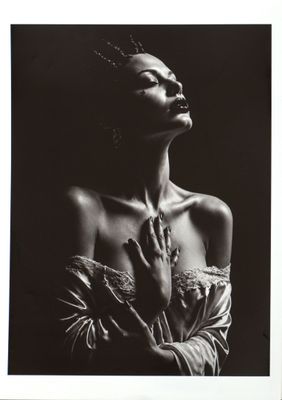 a black and white photo of a woman with her hands on her chest