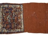 two pieces of cloth with fringes on them on a white surface