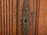 a close up of a door handle on a wooden door