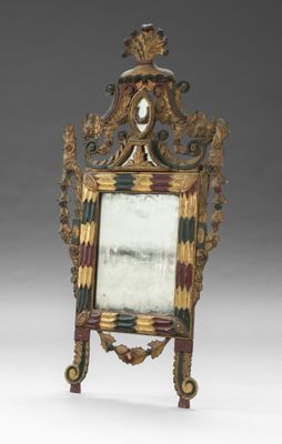 une image représentant un miroir posé sur un pied, sur lequel repose une tête d'homme