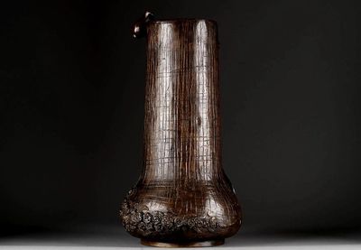 a brown vase that is sitting on a table