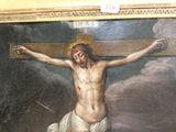 a painting of jesus on the cross in a room