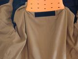 a picture of a jacket that has an orange object in it