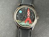 a black watch with a red rocket on it