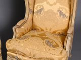 three pieces of furniture including a chair, ottoman, and ottoman