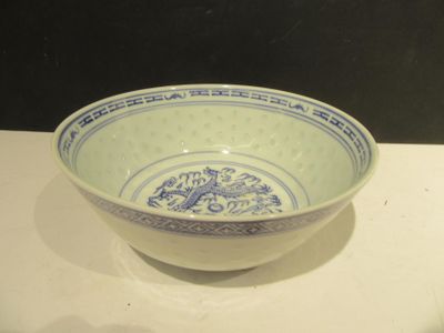 a blue and white bowl sitting on a white table