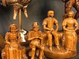 many wooden figurines of people and animals on a table