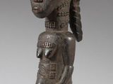 an image of a statue of a woman with a hat on her head