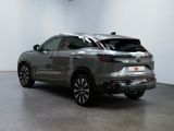 the rear end of a silver suv parked in a garage