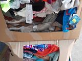 a cardboard box filled with clothes on the street