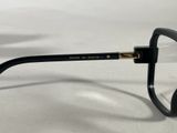 black glasses with clear lenses on a white surface