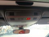 a view of a car ' s rear view mirror from inside the car