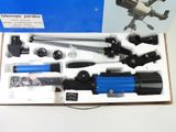 a box with a telescope and other items in it