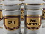 six white and gold canisters with the words pom antips on them