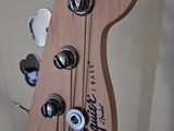 a close up of a guitar neck with a guitar pick up